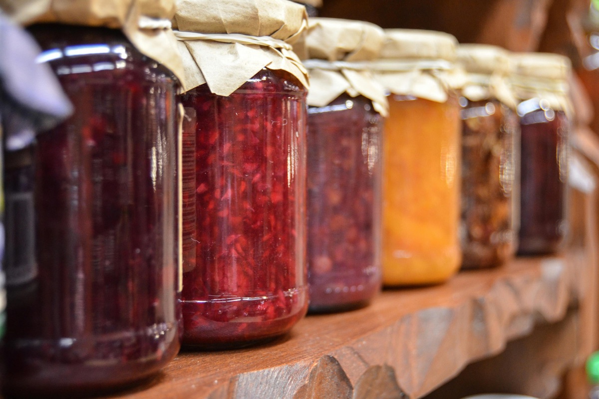 Seasonal preserves jars on a wooden shelf